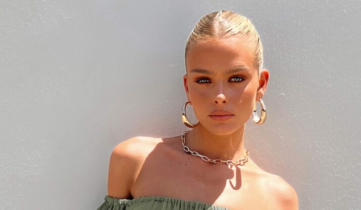 Woman with blonde hair and gold hoop earrings