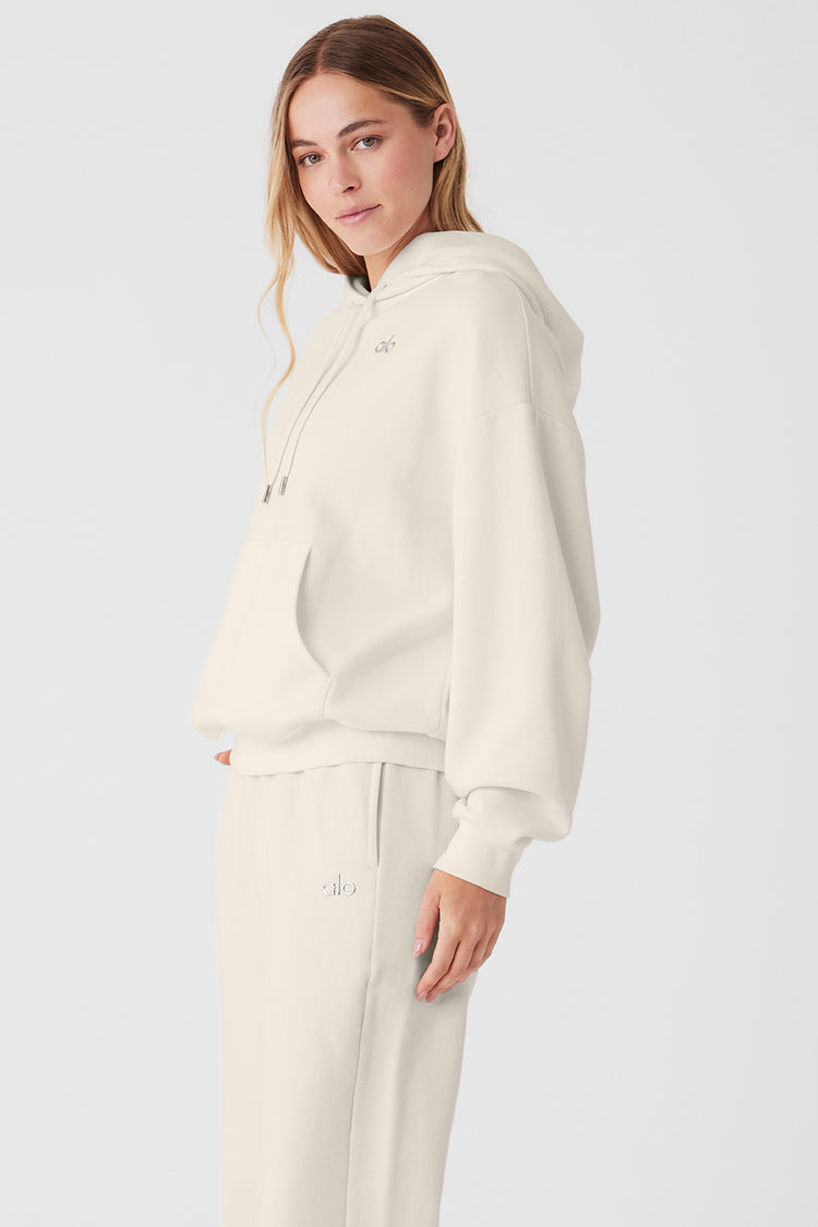 Woman wearing beige hoodie and sweatpants set