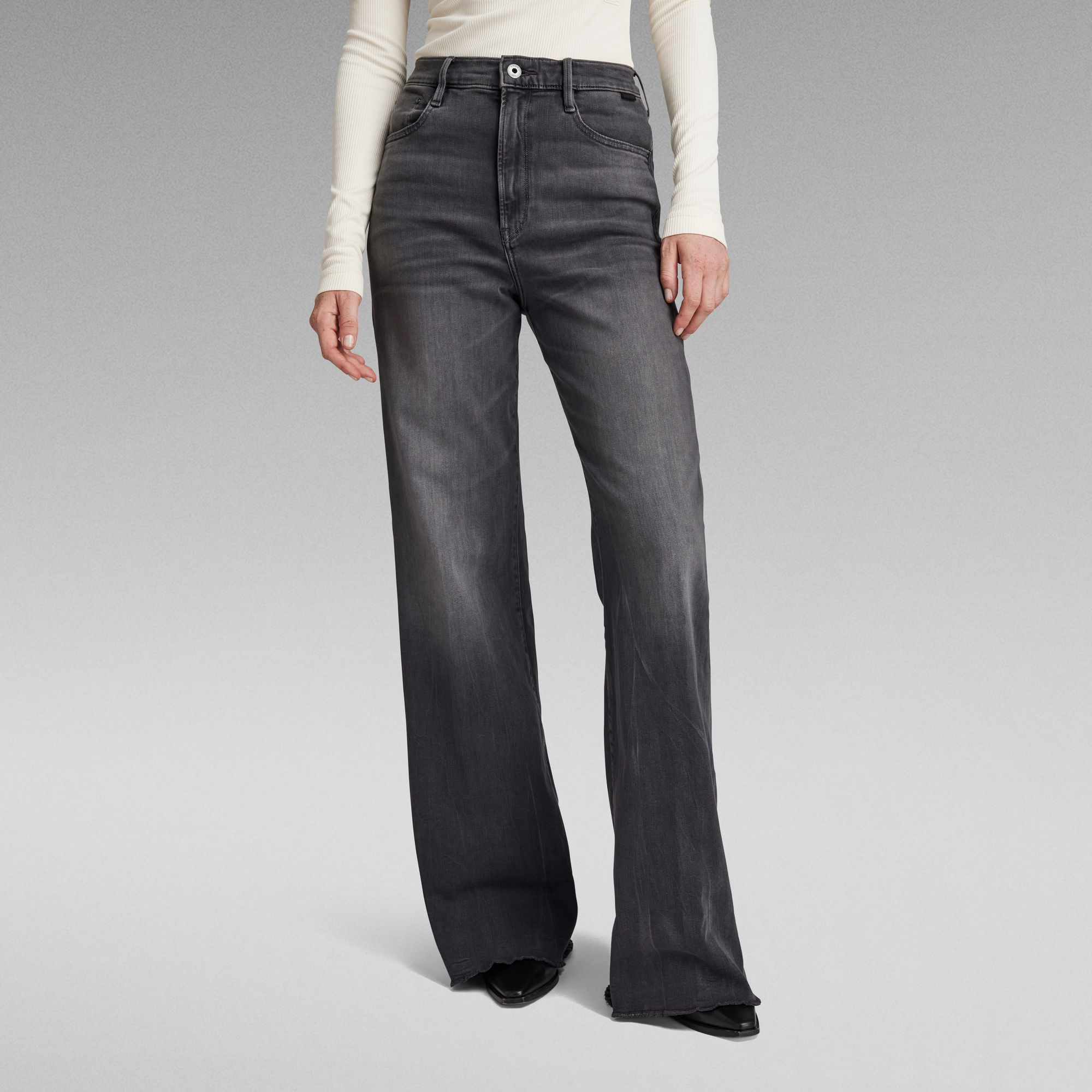 High-waisted black wide-leg jeans on model