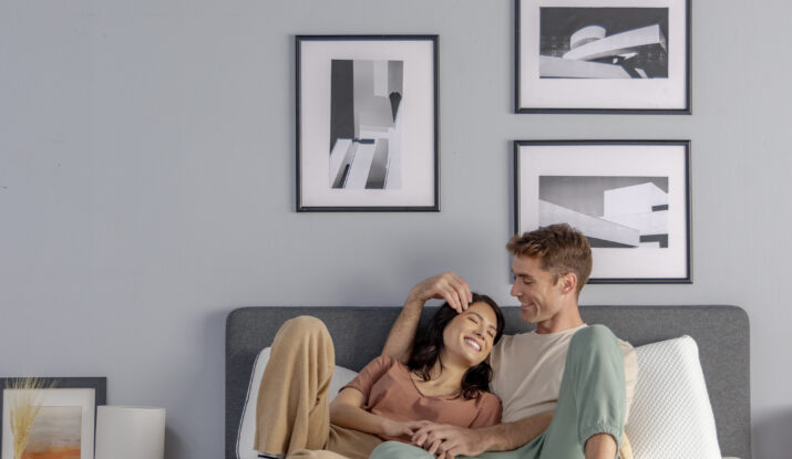Couple relaxing affectionately together on bed