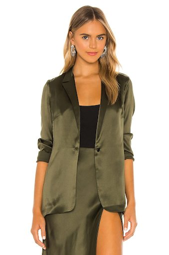 Woman in olive green satin blazer and skirt