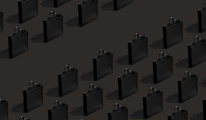 Rows of black paper shopping bags casting shadows