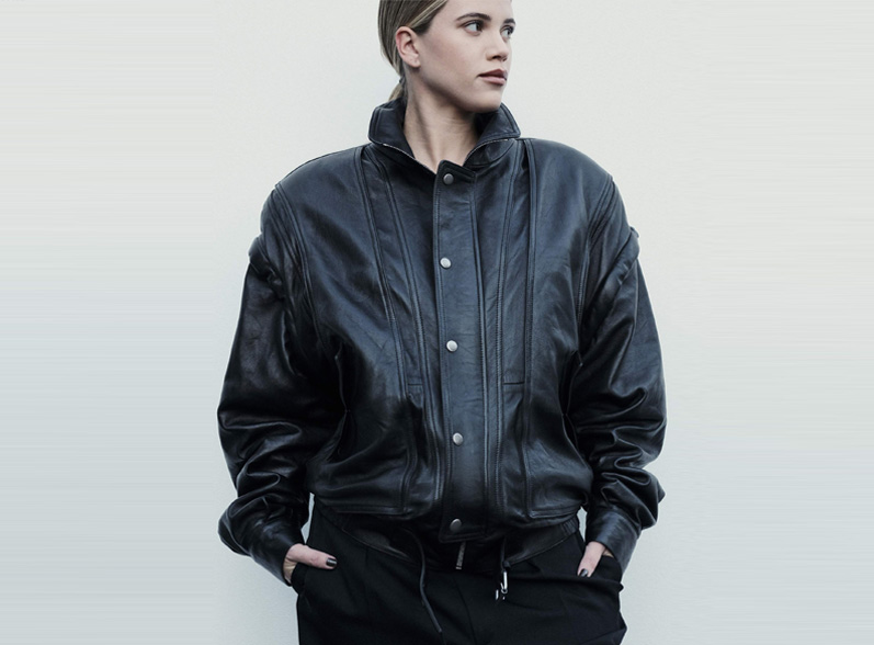 Woman wearing oversized black leather jacket