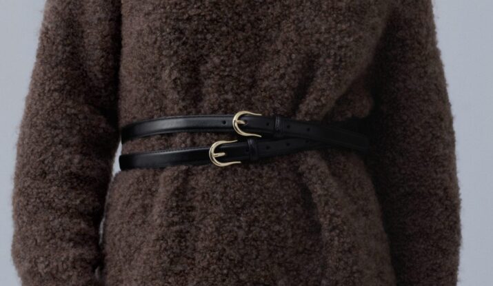 Woman wearing brown textured sweater with black double belt