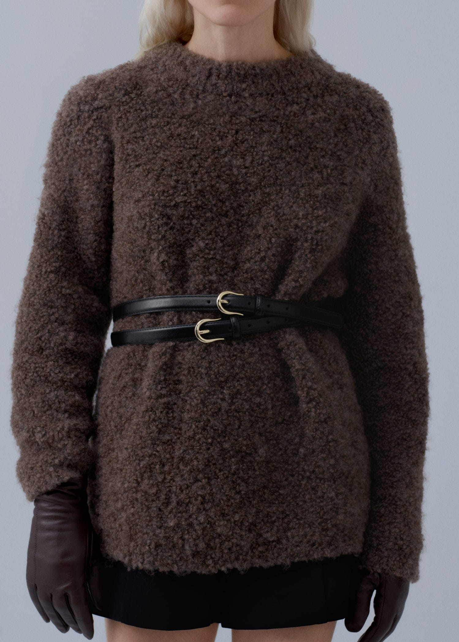 Woman wearing brown textured sweater with black double belt