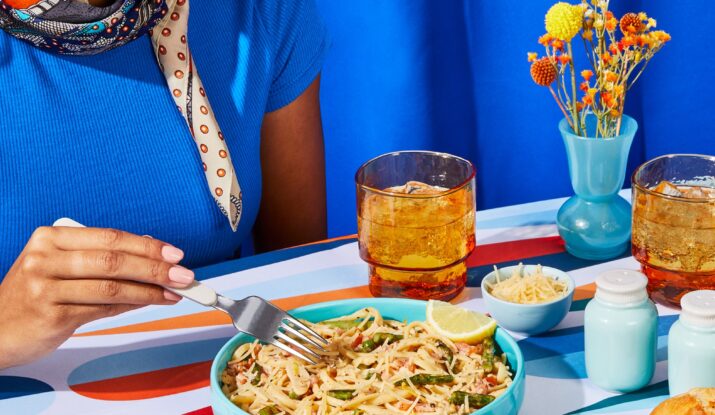 Woman eating pasta with lemon and iced drinks