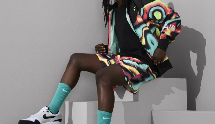 Person wearing colorful outfit and Nike sneakers