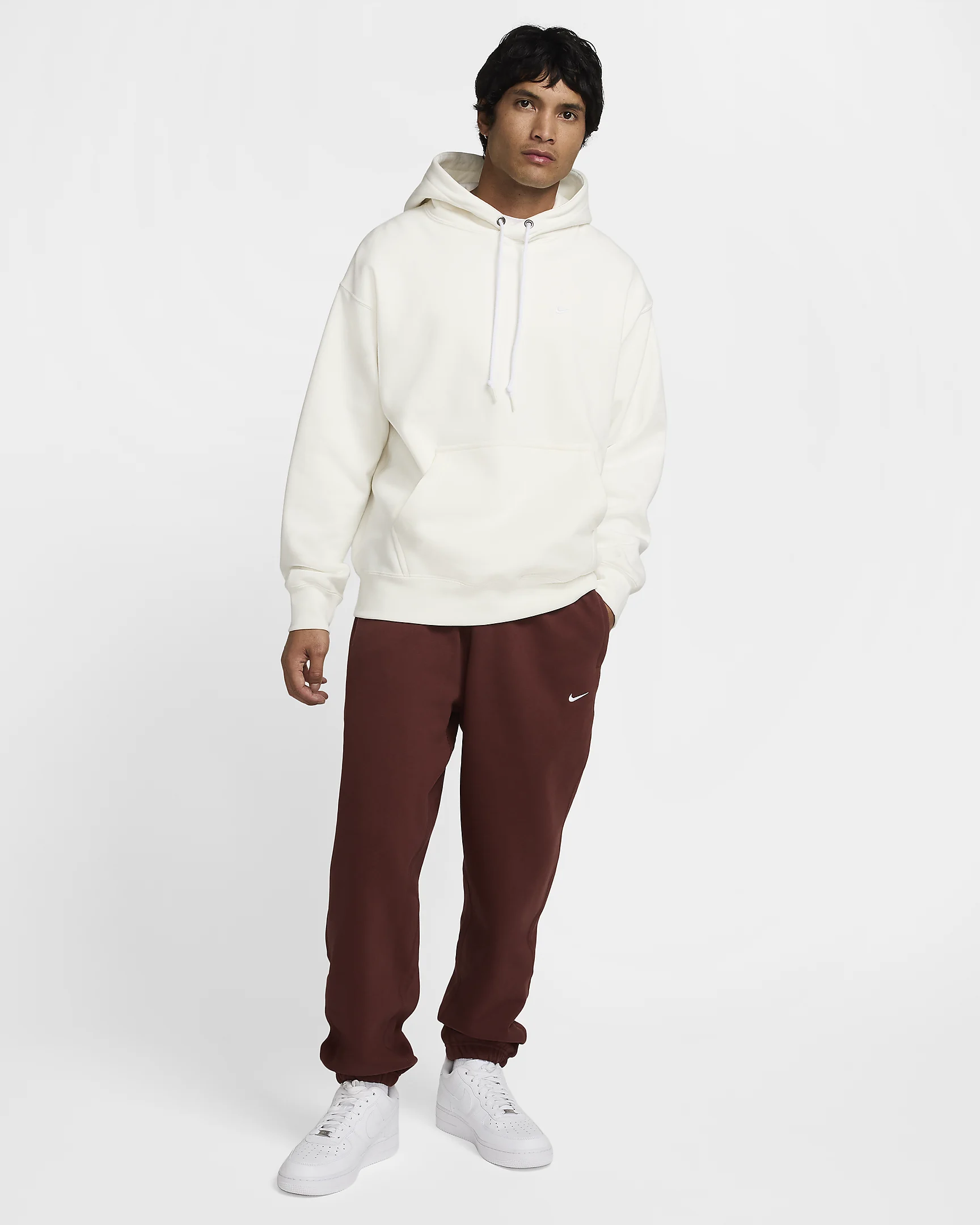 Man in white hoodie and maroon sweatpants