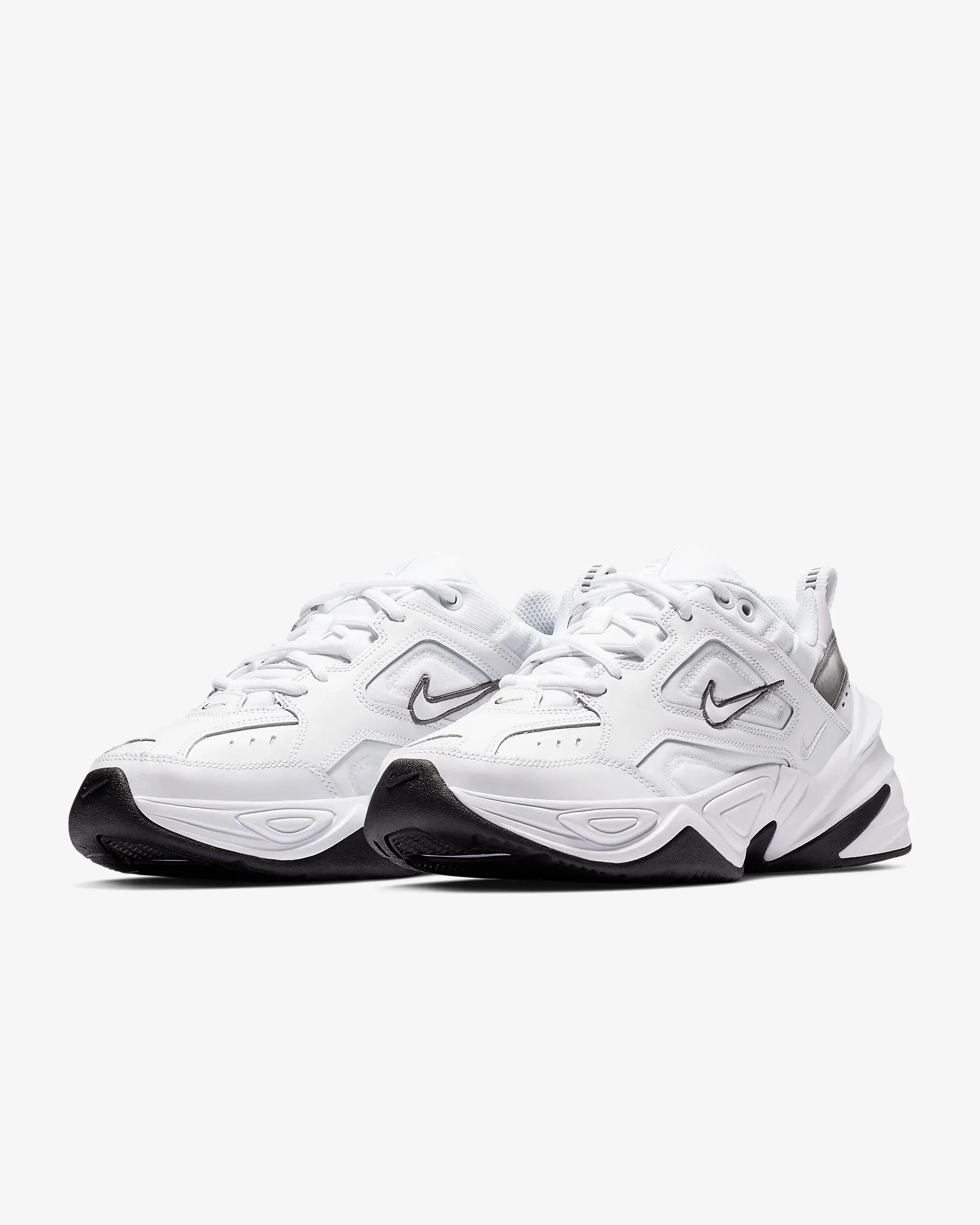 Pair of white Nike sneakers with black soles