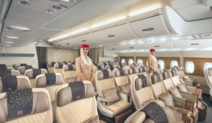 Two flight attendants in spacious airplane cabin seating