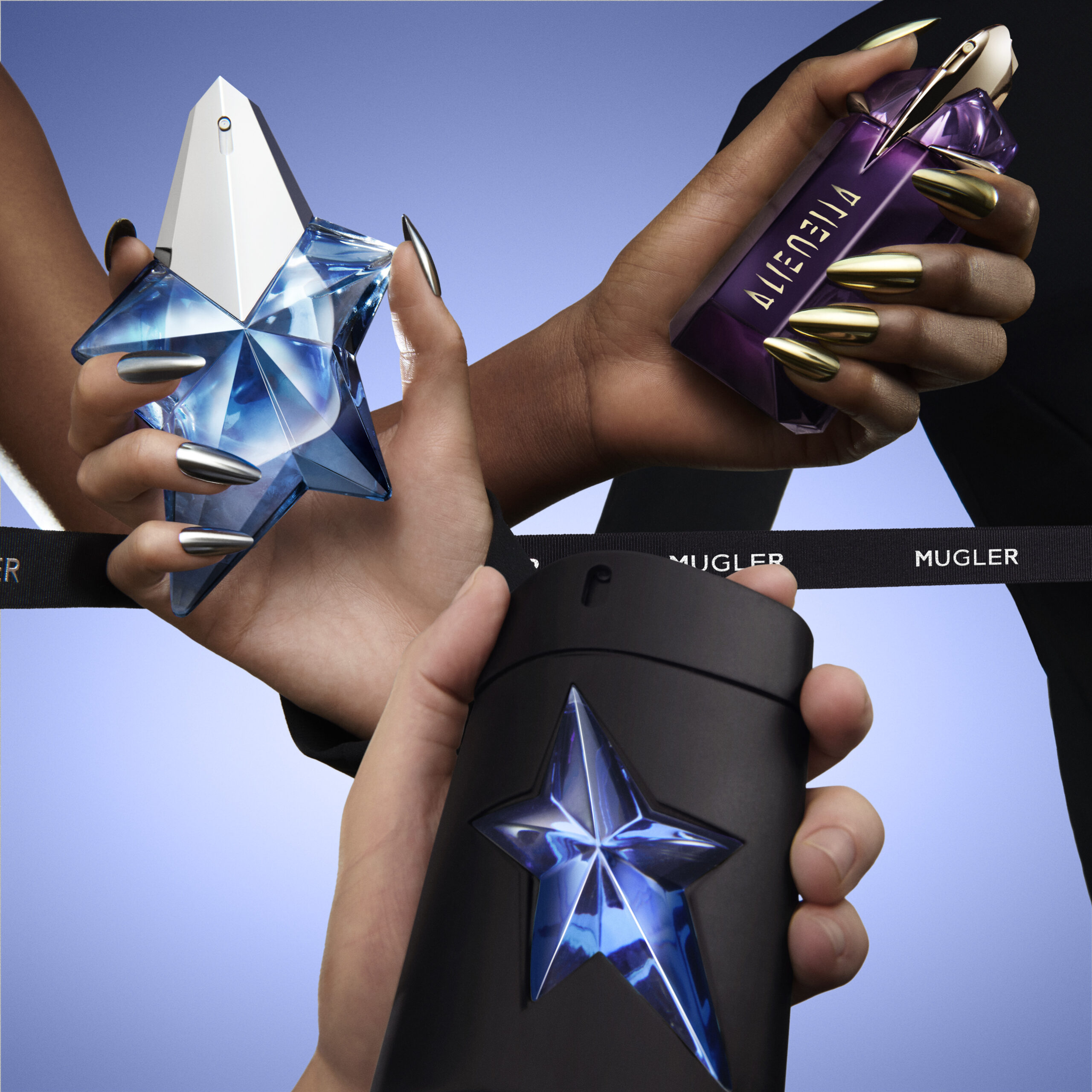 Hands holding distinctive star-shaped perfume bottles