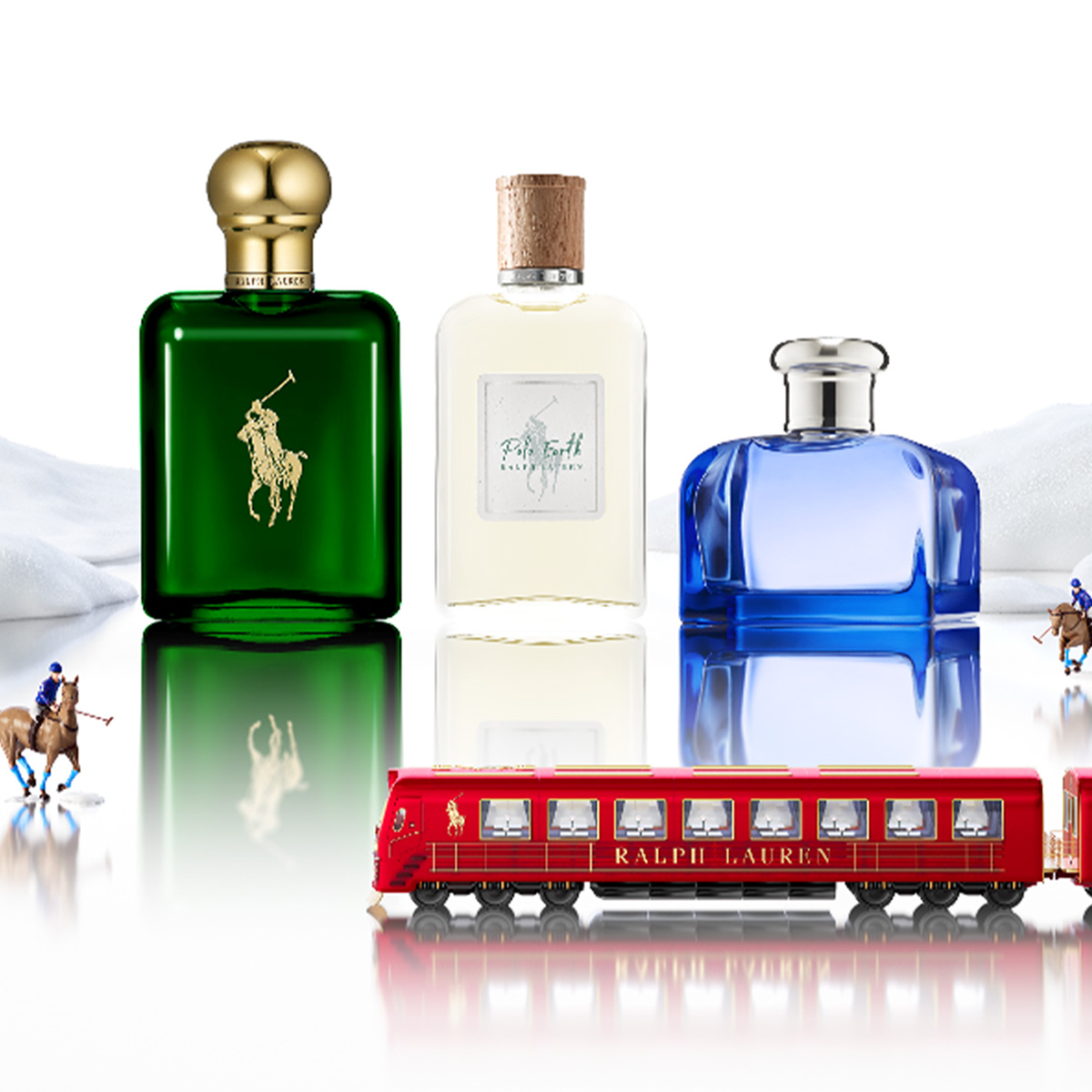 Three Ralph Lauren perfume bottles with toy train and polo players