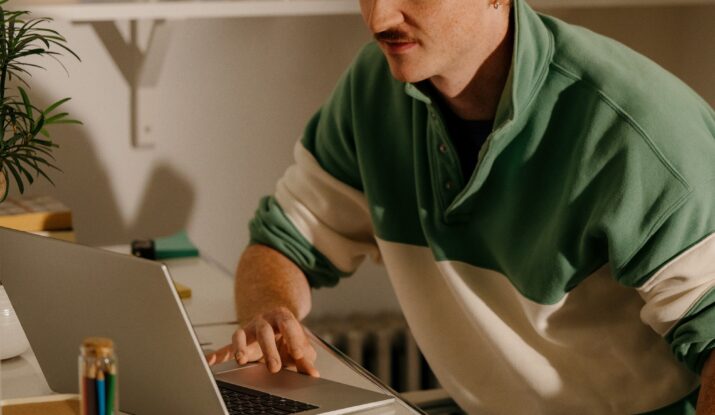 Young man working on laptop at desk