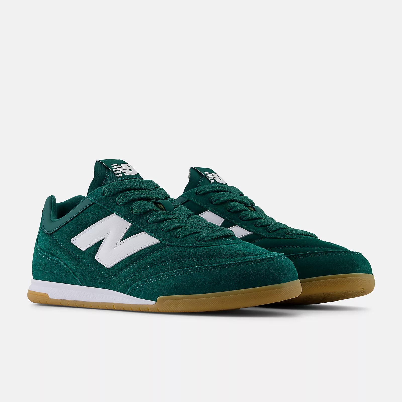 Green New Balance sneakers with white logo and gum soles