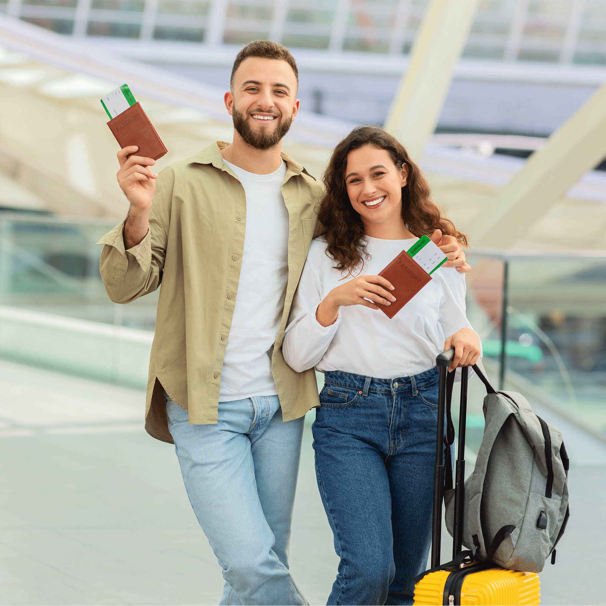 Smiling couple holding passports and boarding passes