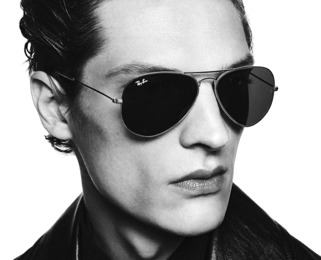 Man wearing Ray-Ban aviator sunglasses and leather jacket