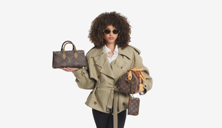 Woman holding two Louis Vuitton handbags wearing sunglasses