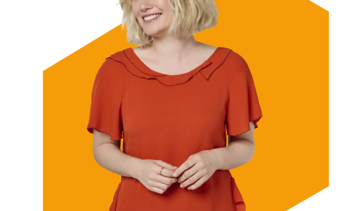 Smiling woman in orange dress with blonde hair