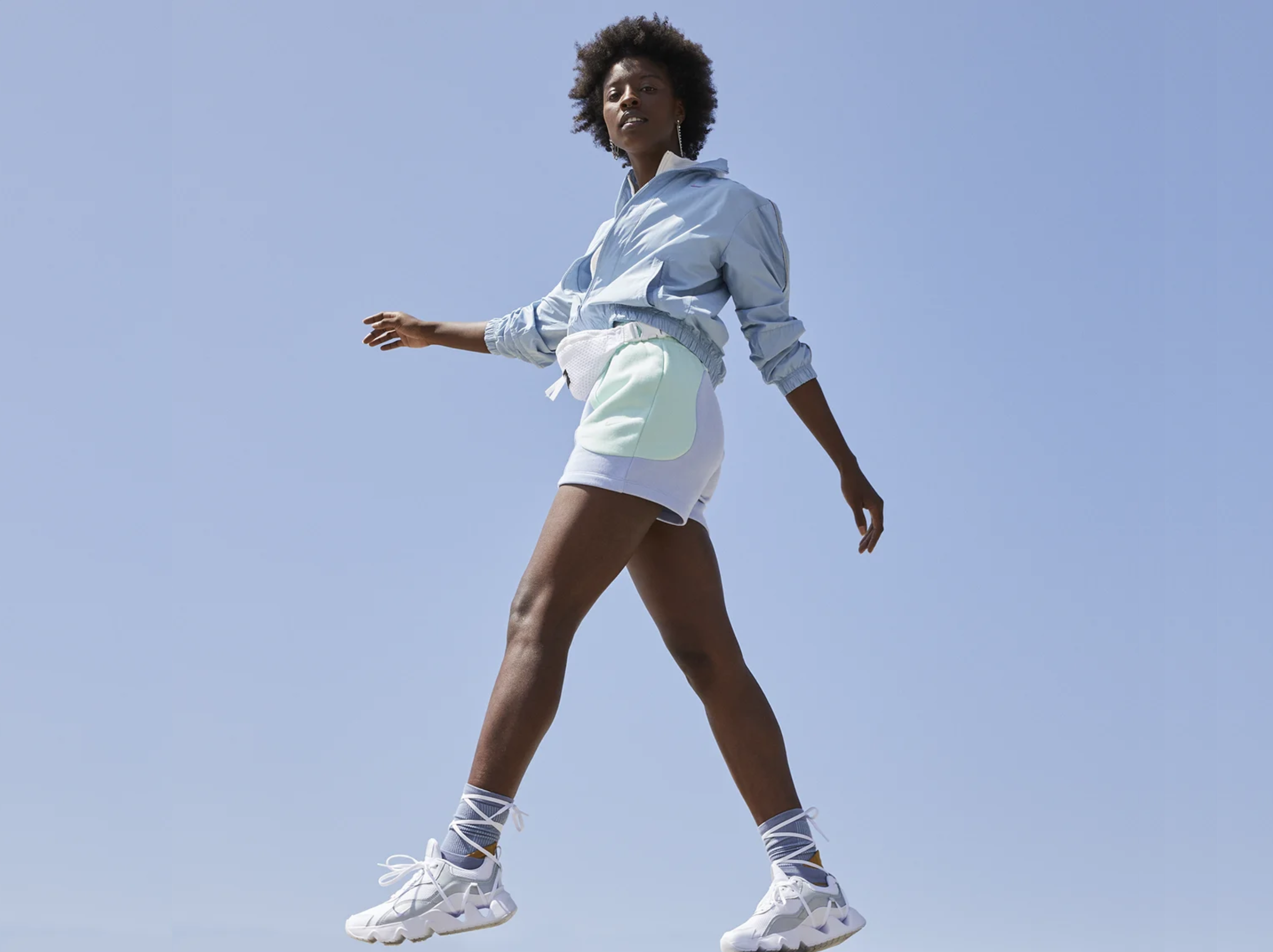 Woman walking outdoors wearing sporty outfit