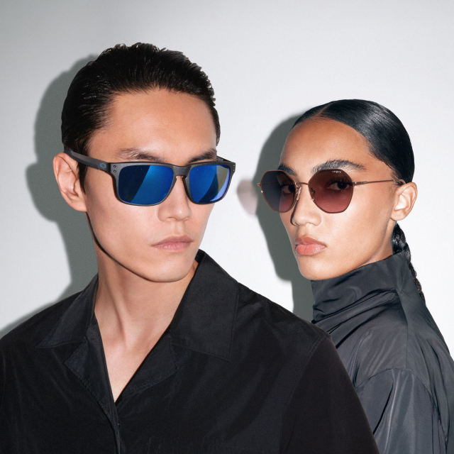 Two people wearing stylish sunglasses and black clothing